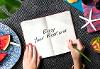 A persons hands with a book saying Happy Weekend.