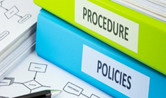 A blue and green file with the words Procedure and Policies on them.