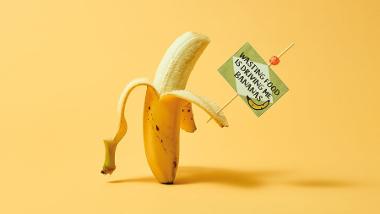 Banana holding sign 'wasting food is driving me bananas'